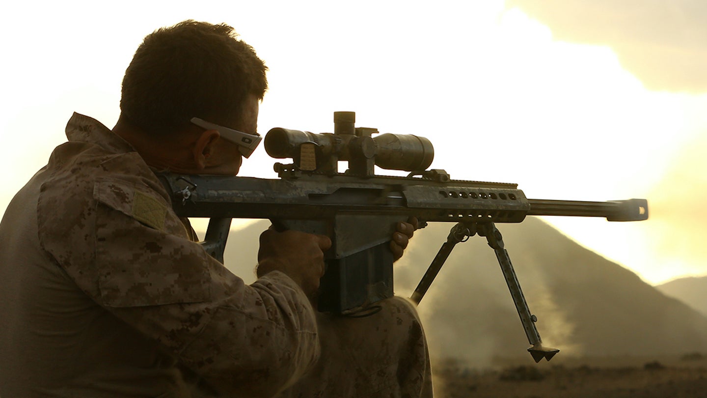 U.S. Marine Corps Staff Sgt. Steven D. Holland, a reconnaissance Marine with Force Reconnaissance detachment, 11th Marine Expeditionary Unit (MEU), and native of Riverside, California, fires an XM107 Special Application Scoped Rifle (SASR) during sustainment training in D'Arta Plage, Djibouti, Nov. 12, 2014.
