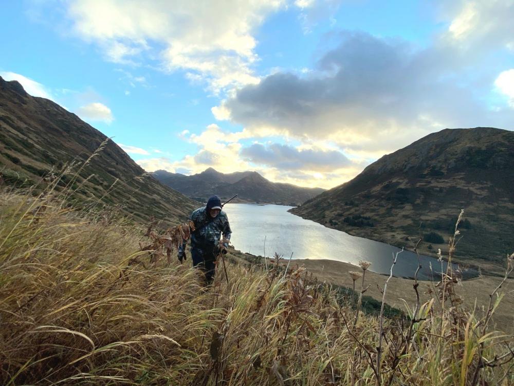 Steve Penn, a resident of Kodiak Island, climbs a hill on Afognak Island, Alaska, on Oct. 13, 2021. Penn is a lifelong hunter and has resided in the state for nearly 30 years. (Photo courtesy Senior Airman Brady Penn)