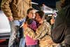 Sgt. Audra Gallagher, assigned to HHC 192nd Military Police hugs her daughter at the Army Aviation Support Facility in Windsor Lock, Conn. on Nov. 24, 2020 following deployment. The unit was deployed throughout most of 2020 to the U.S. Southern Command area of responsibility. U.S. Army National Guard photo by Capt. Dave Pytlik.