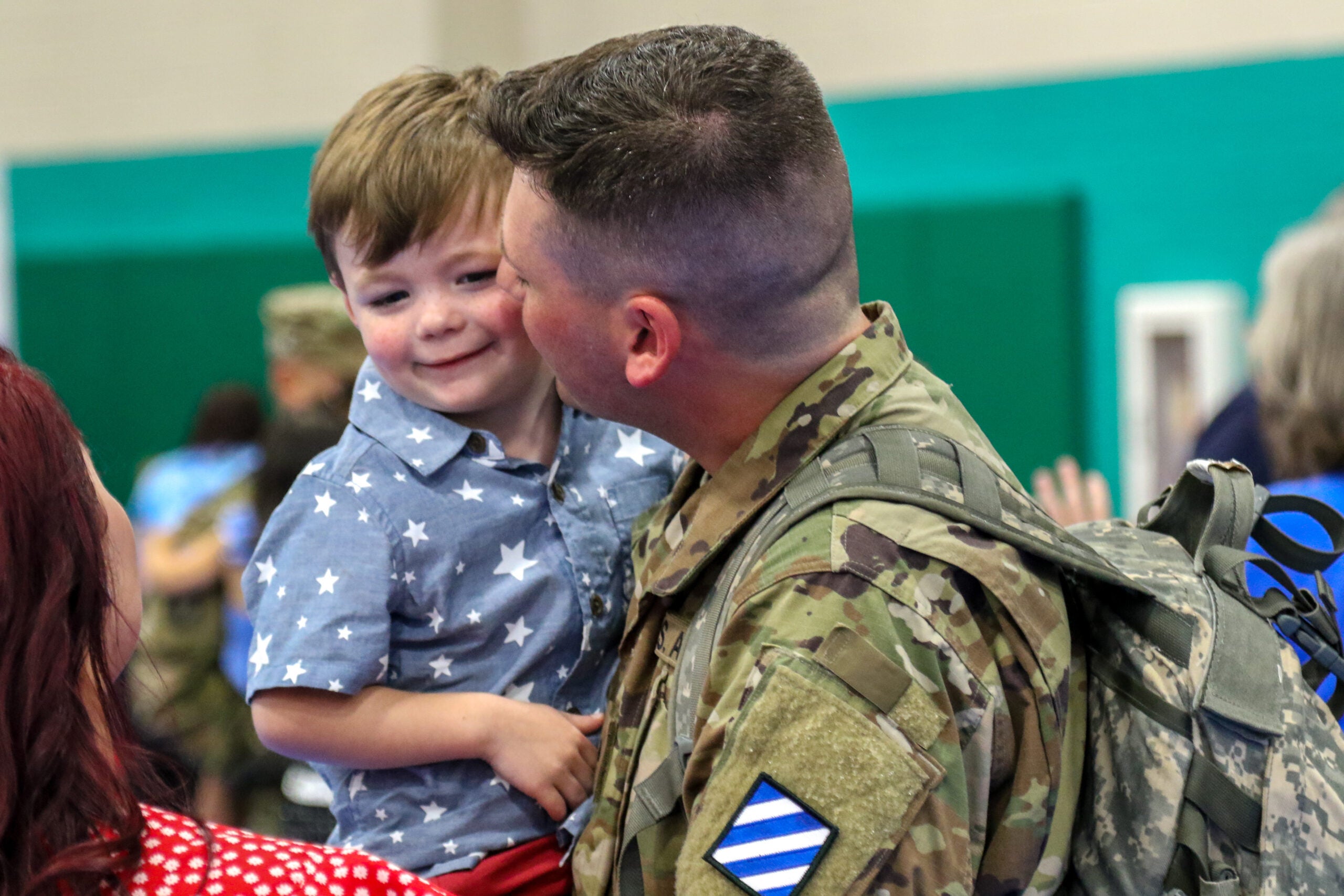 Cpl. Anthony La Rocco shares a tearful reunion with his son during the 1st Armored Brigade Combat Team, 3rd Infantry Division return to Fort Stewart, Georgia, July 2, following a nine-month deployment to South Korea. The Raider Brigade was one of the first in the Army to resume major training events and deploy amidst the COVID-19 pandemic, developing procedures adopted across the Army in order to maintain mission readiness and global commitments to allies and partners. (U.S. Army photo by Sgt. 1st Class Jason Hull)