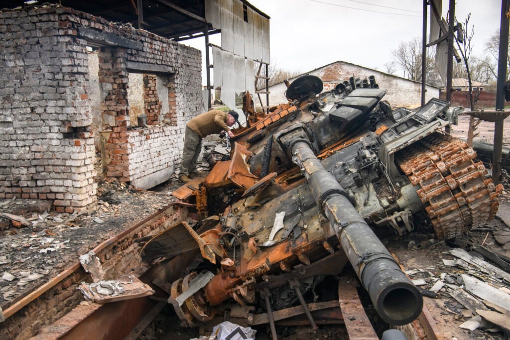 A man looks at Russian T-72 tank destroyed during Russia's invasion to Ukraine, Ivanivka village, Chernihiv area, Ukraine, April 20, 2022 (Maxym Marusenko/NurPhoto via Getty Images)