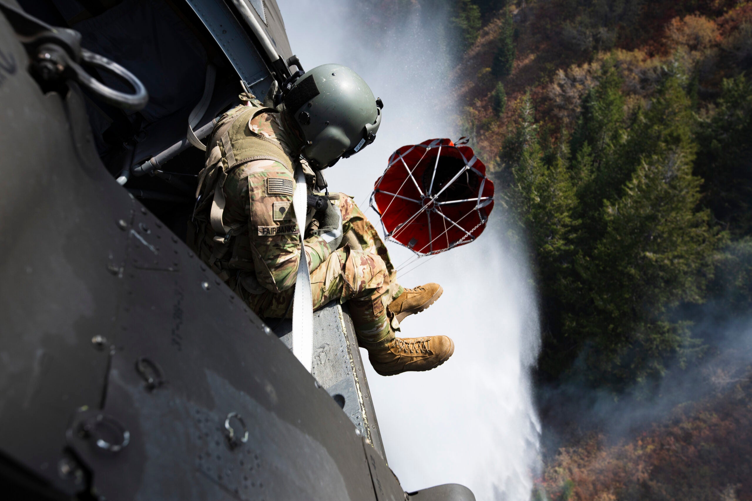 Crew members of the 211th Aviation Regiment conduct air support over the Neffs Canyon fire from a UH-60 Blackhawk helicopter in Salt Lake City, Utah, 20 September 2020. The Blackhawk can drop 600 gallons of water over a wildfire each drop. (U.S. National Guard Photo by Spc. Jacob Jesperson)