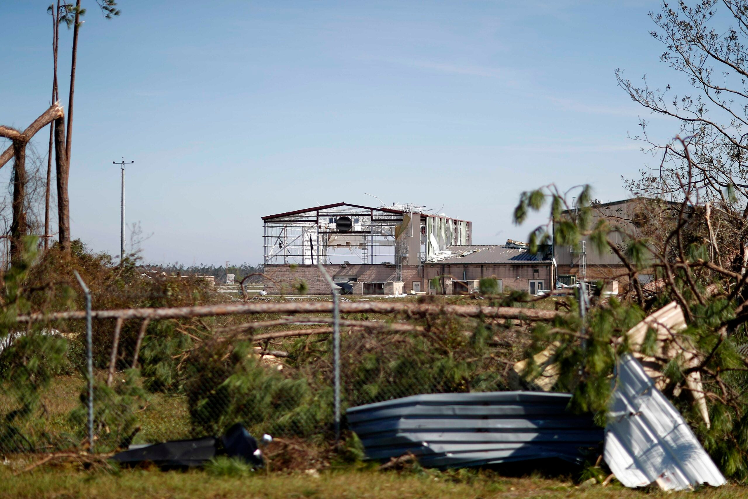 FILE - In this Oct. 11, 2018, photo, an airplane hanger at Tyndall Air Force Base is damaged from hurricane Michael in Panama City, Fla. The U.S. military long has formally recognized climate change as a threat to national security. That's in part because of the impact that intensifying floods, wildfires, extreme heat and other natural disasters are having and will have on U.S. installations and troops around the world. (AP Photo/David Goldman, File)