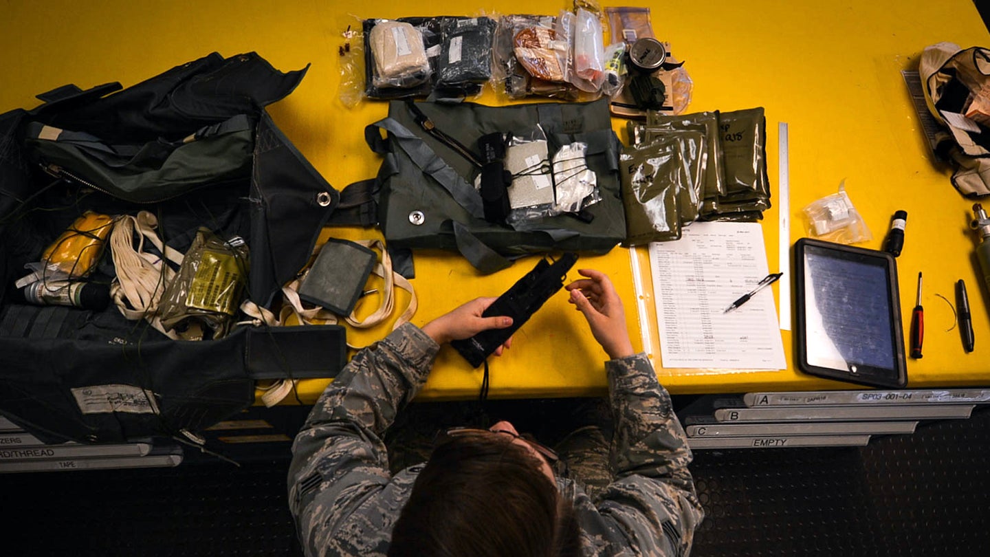 U.S. Air Force Senior Airmen Brittany Cup Choy, 20th Operations Support Squadron aircrew flight equipment journeyman, packs an ACES II ejection seat survival kit at Shaw Air Force Base, S.C., March 7, 2018.