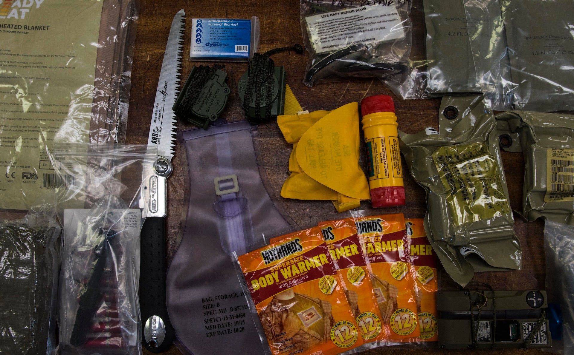 Components of an F-35A Lightning II arctic survival kit lie on a table at Eielson Air Force Base, Alaska, April 24, 2019. A standard survival kit includes a compass, a flare and a five-inch knife. The cold-weather kit also includes components intended to increase survival chances in environments where temperatures reach negative 40 degrees Fahrenheit and below. 
