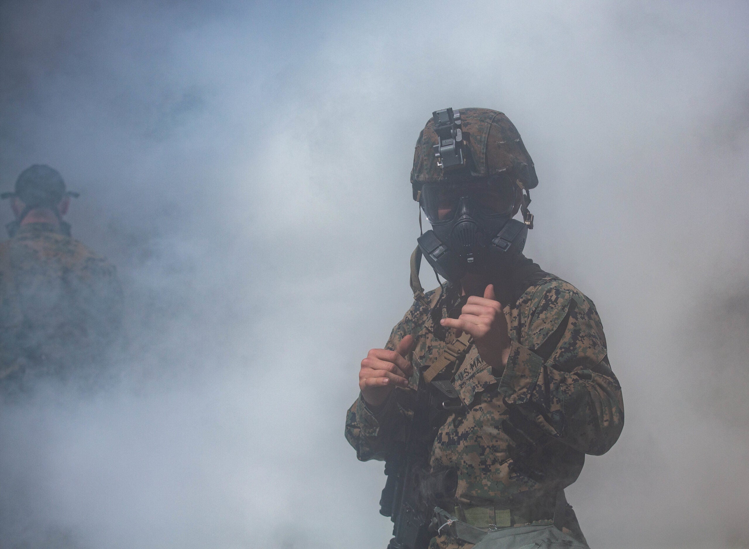 U.S. Marine Corps Cpl. David Rodriguez, a human intelligence specialist with Headquarters Company, Headquarters Battalion, 2d Marine Division  poses for a photo during a Battalion Field Exercise at Camp Lejeune, North Carolina, March 18, 2020. The  exercise focused on mission readiness, lethality, and combat effectiveness within the Division. The training included defensive combat procedures, chemical weapons readiness, communications, and convoy operations. (U.S. Marine Corps photo by Lance Cpl. Brian Bolin Jr.)