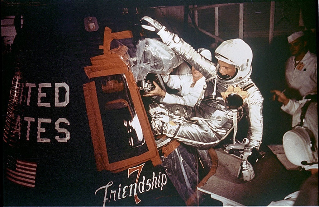 376869 01: Astronaut John Glenn, Jr. is loaded into the Friendship 7 capsule in preparation for flight on the Mercury Titan rocket February 20, 1962