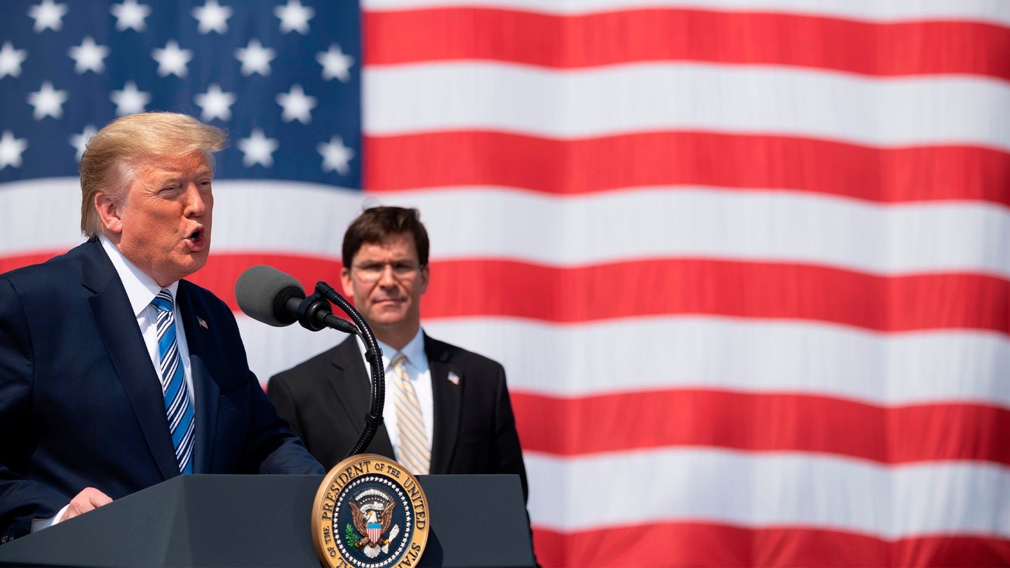 Then-President Donald Trump, with former Defense Secretary Mark Esper, during the departure ceremony for the hospital ship USNS Comfort at Naval Base Norfolk on March 28, 2020, in Norfolk, Virginia. (Jim Watson/AFP via Getty Images)