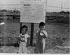 Two Japanese American boys outside the Pinedale Assembly Center in Pinedale, California, circa 1942. 
The camp was a temporary detention facility for some of the 120,000 Japanese Americans excluded from the West Coast under wartime presidential Executive Order 9066. (Photo by U.S. Army Signal Corps photo./Library of Congress/Corbis/VCG via Getty Images)