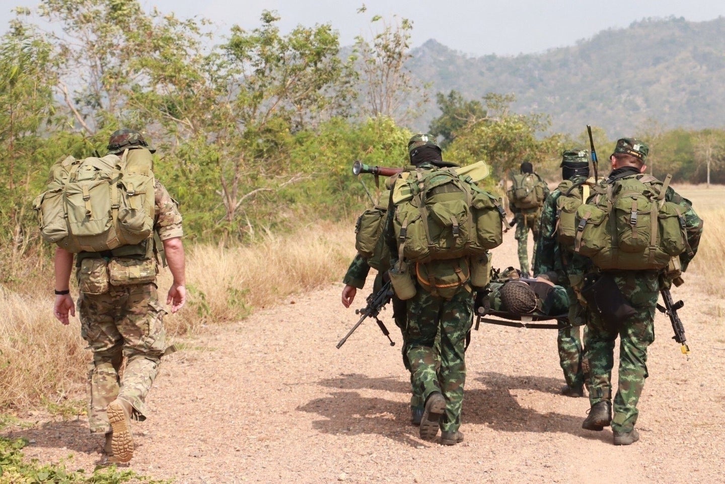A Green Beret with 1st Special Forces Group (Airborne) accompanies Rangers from the Royal Thai Army 3rd Special Forces Regiment moving a simulated casualty to an extraction point during training March 14-25, 2022. This exchange strengthens coordination and bolsters relationships between U.S. and Thai special operations. A strong, forward-looking U.S.-Thai defense alliance, rooted in history, helps foster a free and open Indo-Pacific region where all countries in the region enjoy prosperity and peace. (U.S. Army courtesy photo)