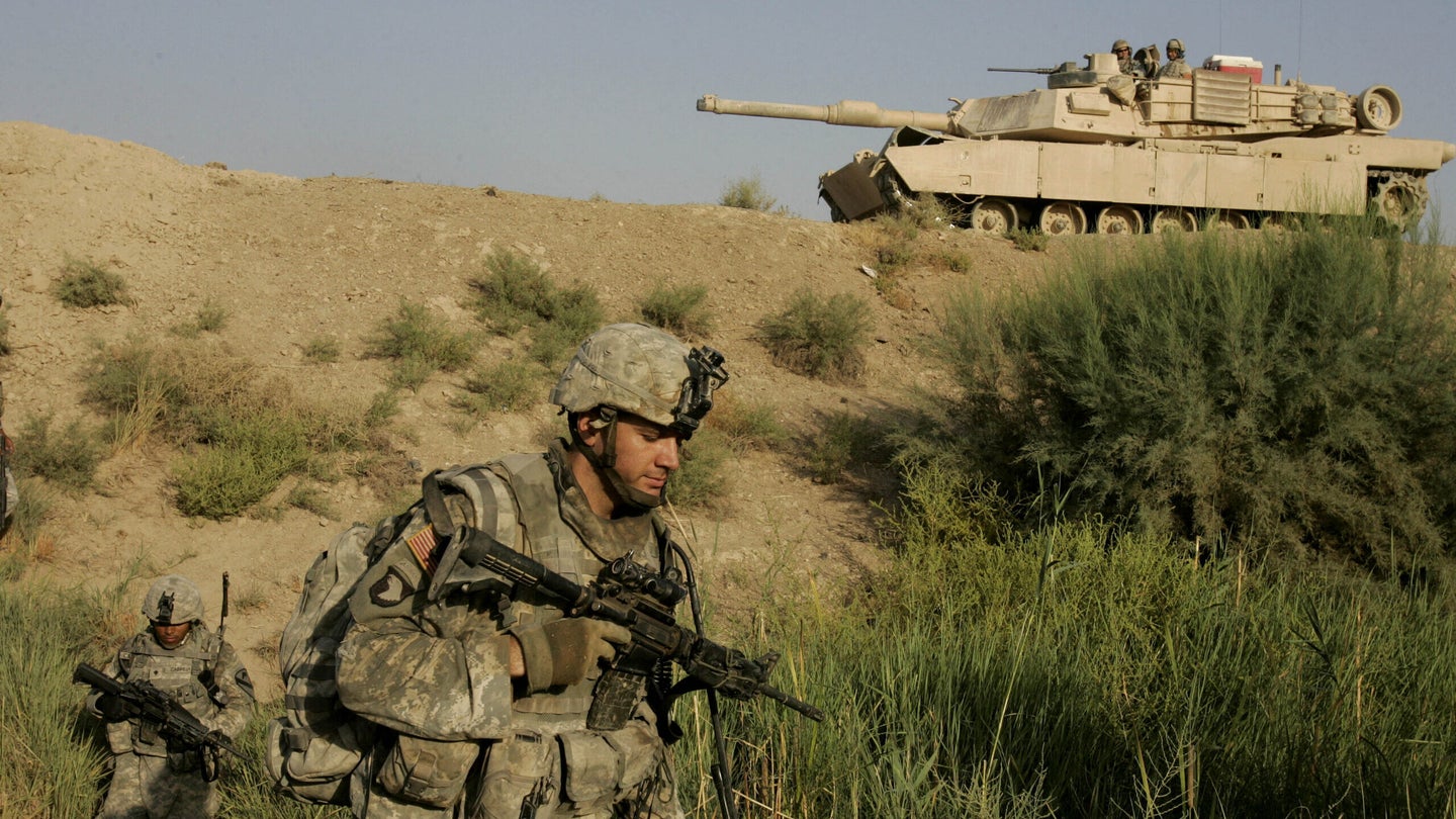 A U.S soldier from Bravo 1-12 Cav. Battalion walk past an Abrahams tank during operation Wickersham 3 near the city of Baqouba, 60 kilometers (35 miles) northeast of Baghdad on Friday, Sept, 7, 2007.Operation Wickersham 3 was held over 40 hours to flush out suspected insurgents in the Baqouba area. (Karel Prinsloo/AP)