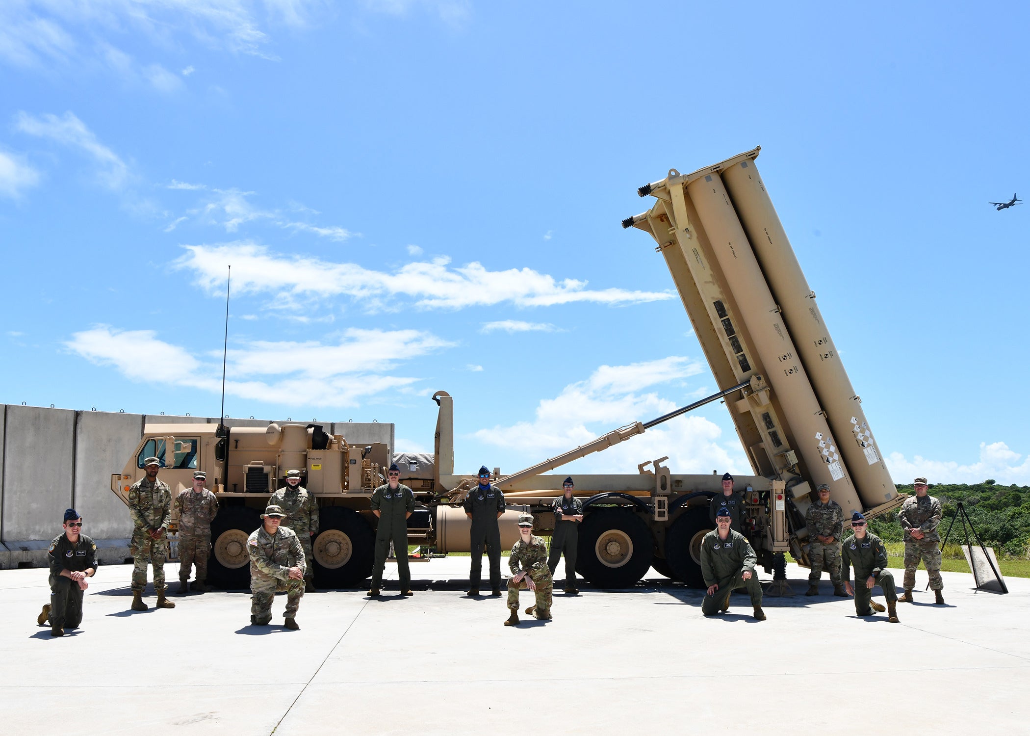 U.S. Army E3 Terminal High Altitude Area Defense soldiers and deployed Bomber Task Force U.S. Airmen, pose for a photo in front of a THAAD anti-ballistic missile defense system during a U.S. Army led tour on North West Field at Andersen Air Force Base, Guam, May 12, 2021. The THAAD mission is to protect the homeland, deployed military forces, friends, and allies from short, medium, and intermediate range ballistic missiles. The BTF was deployed to the U.S. Indo-Pacific Command area of responsibility to meet Pacific Air Forces training objectives. PACAF in coordination with other components, allies, and partners, provides USINDOPACOM with continuous unrivaled air, space, and cyberspace capabilities to ensure regional stability and security. (U.S. Air Force photo by Master Sgt. Louis Vega Jr.)