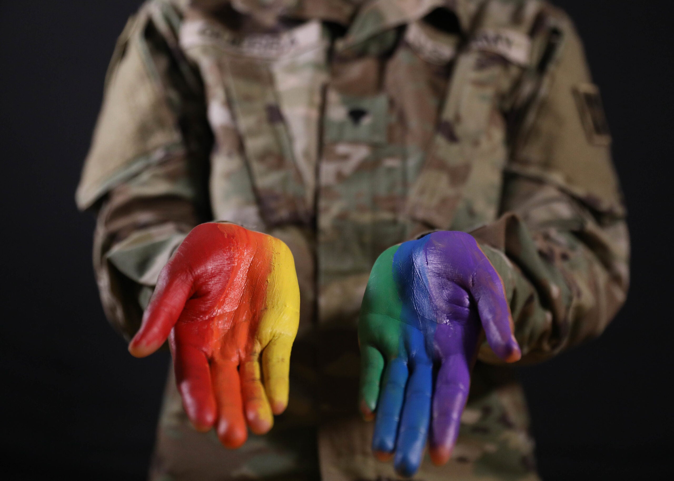 Spc. Sevyn Guerra, a Human Resources Specialist, assigned to Headquarters and Headquarters Battalion, 4th Infantry Division, captured for a Pride Month photo shoot on June 22, 2021 at Fort Carson, Colorado. Guerra poses with her hands painted as the colors of the Pride flag to celebrate Pride Month. (U.S. Army photo by Pfc. Collin MacKown)