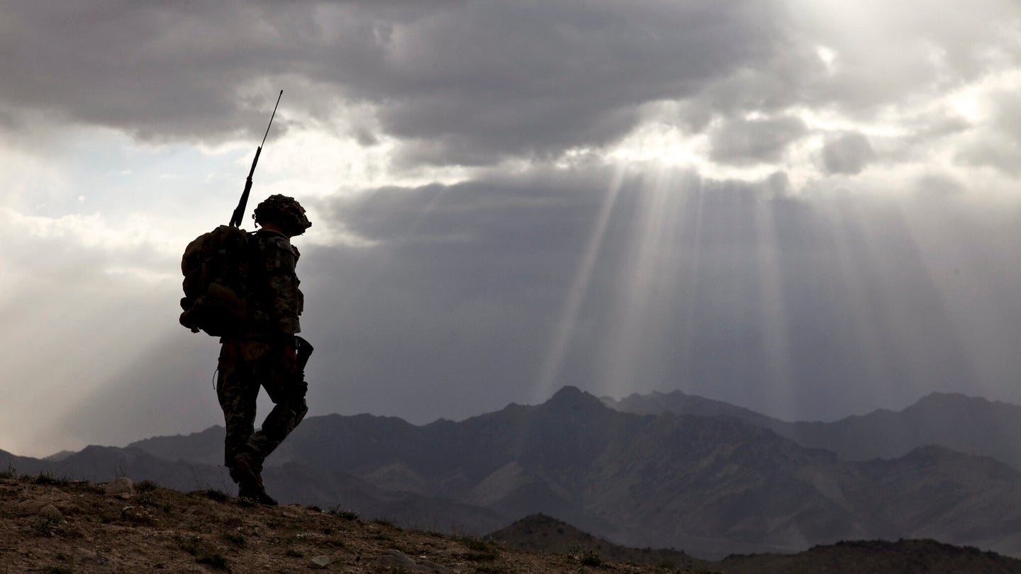 U.S. Army Spc. Newton Carlicci travels dismounted while on his way back to his outpost from the village of Paspajak, Charkh District, Logar province, Afghanistan, June 20, 2010. (U.S. Army)