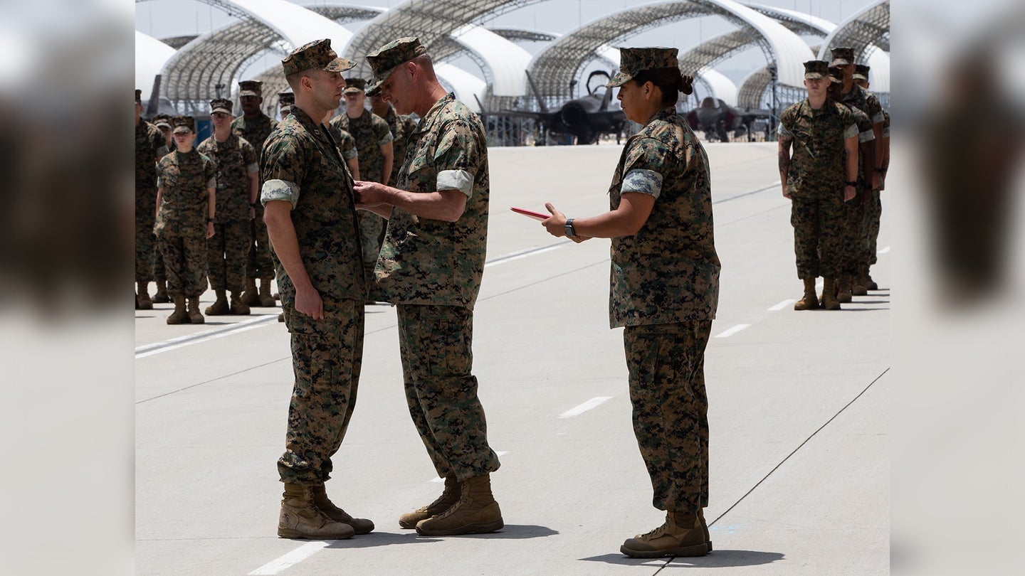 U.S. Marine Corps Capt. Michael Wolff, a KC-130J Super Hercules pilot with Marine Aerial Refueler Transport Squadron 352, Marine Aircraft Group 11, 3rd Marine Aircraft Wing (MAW), receives the Distinguished Flying Cross from Maj. Gen. Bradford J. Gering, 3rd MAW commanding general, at Marine Corps Air Station Miramar, California, May 25, 2022. (U.S. Marine Corps photo by Cpl. Rachaelanne Woodward)