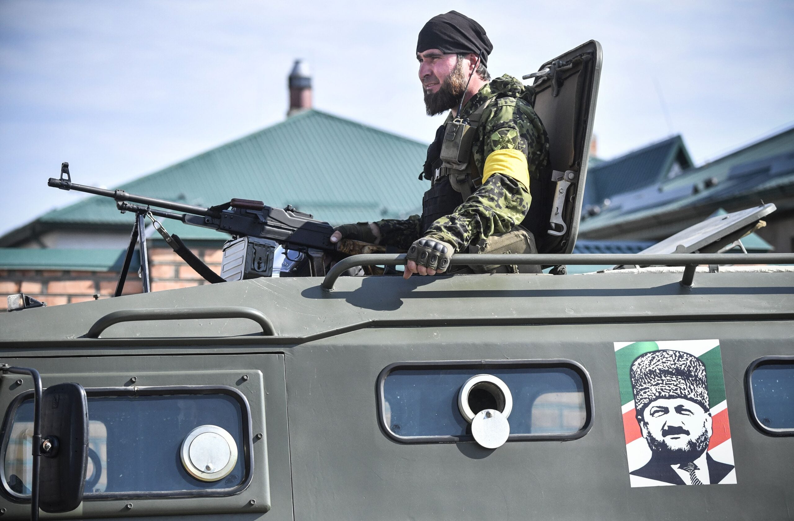 A Chechen special force trooper sits atop an APC decorated with a portrait of former Chechen president Akhmad Kadyrov, the father of the current Chechen leader Ramzan Kadyrov, during a training session at a 'Russian Spetsnaz University' special force training centre in the town of Gudermes in Chechnya on July 25, 2019. (Photo by Alexander NEMENOV / AFP)        (Photo credit should read ALEXANDER NEMENOV/AFP via Getty Images)