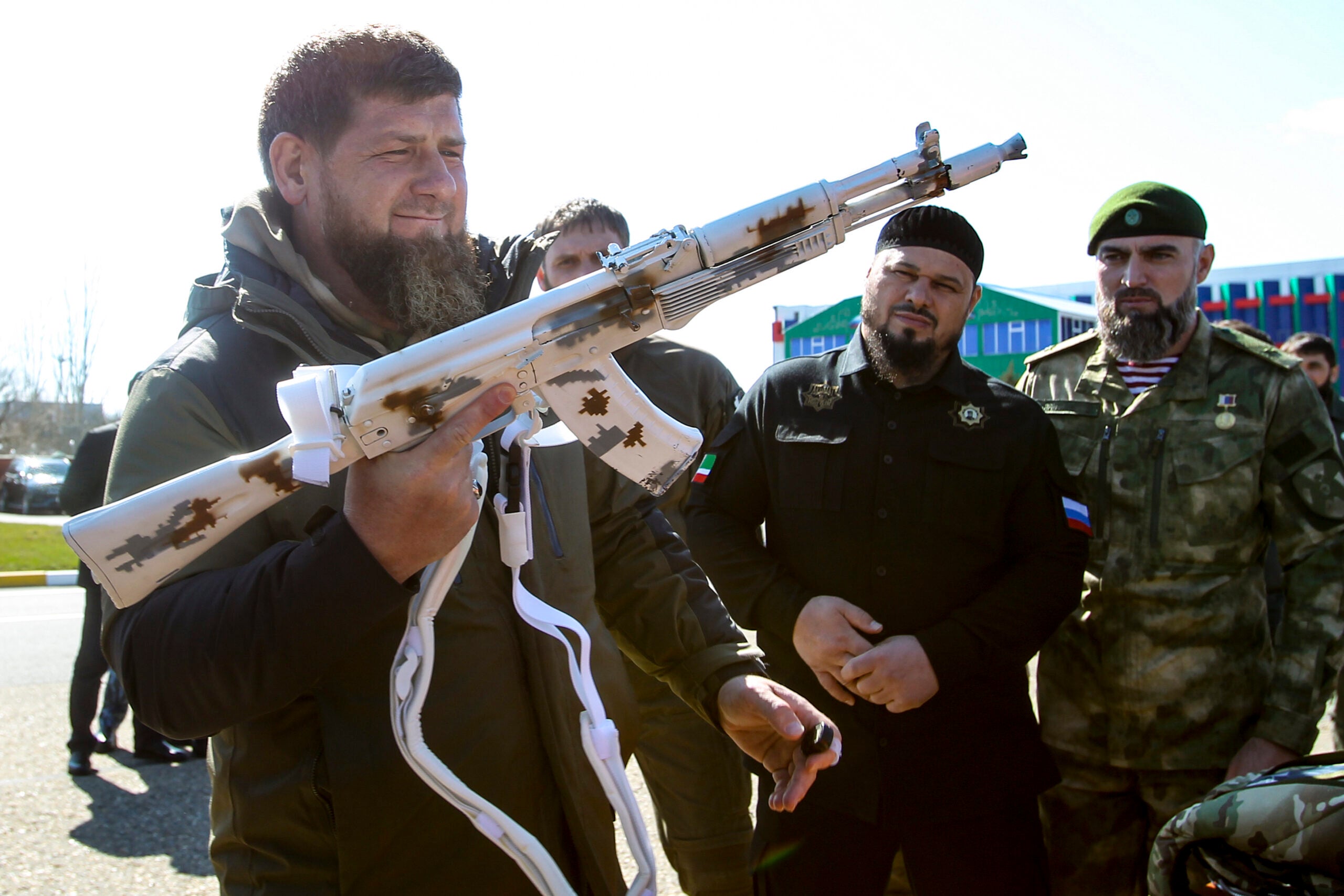 Chechnya's regional leader Ramzan Kadyrov holds a white painted Kalashnikov machine gun as he inspects troops before their deployment for an exercise in the Arctic at an airport outside Grozny, Russia, Tuesday, March 9, 2021. (AP Photo/Musa Sadulayev)