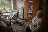 An eldery woman sits inside her damaged house after a missile strike in the city of Soledar, in the eastern Ukrainian region of Donbas on June 4, 2022. - Russian artillery is slamming Ukraine's eastern Donbas region with fierce fighting over the city of Severodonetsk, but the local governor says there was some progress in pushing back invading forces. (Photo by ARIS MESSINIS / AFP) (Photo by ARIS MESSINIS/AFP via Getty Images)