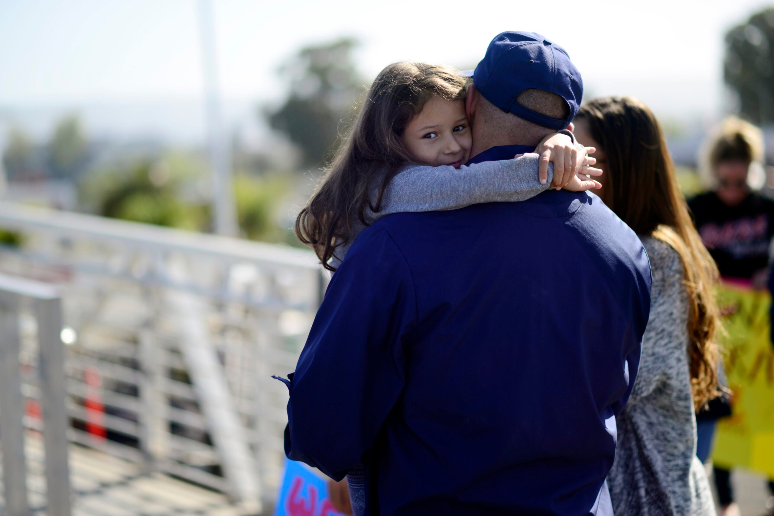 A father embraces his daughter after she embarks on the Coast Guard Cutter Stratton April 2, 2017, on Coast Guard Island in Alameda, Calif. The Stratton returned home after offloading approximately 12,000lbs of cocaine in San Diego before returning home. U.S. Coast Guard photo by Petty Officer 3rd class Adam Stanton