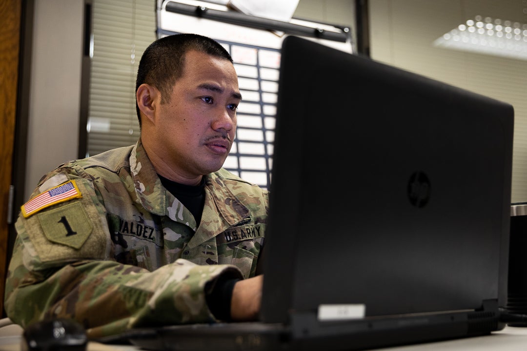 U.S. Army Staff Sgt. Albert Valdez, a motor transport operator assigned to the Headquarters and Headquarters Company, 143rd Combat Sustainment Support Battalion, Connecticut Army National Guard, works on a computer at the State Commodity Warehouse, New Britain, Connecticut, March 8th, 2022. Valdez has been part of the COVID-19 relief mission since August 2020 and has been handling inventories at the warehouse since 2021. (U.S. Army photo by Sgt. Matthew Lucibello)