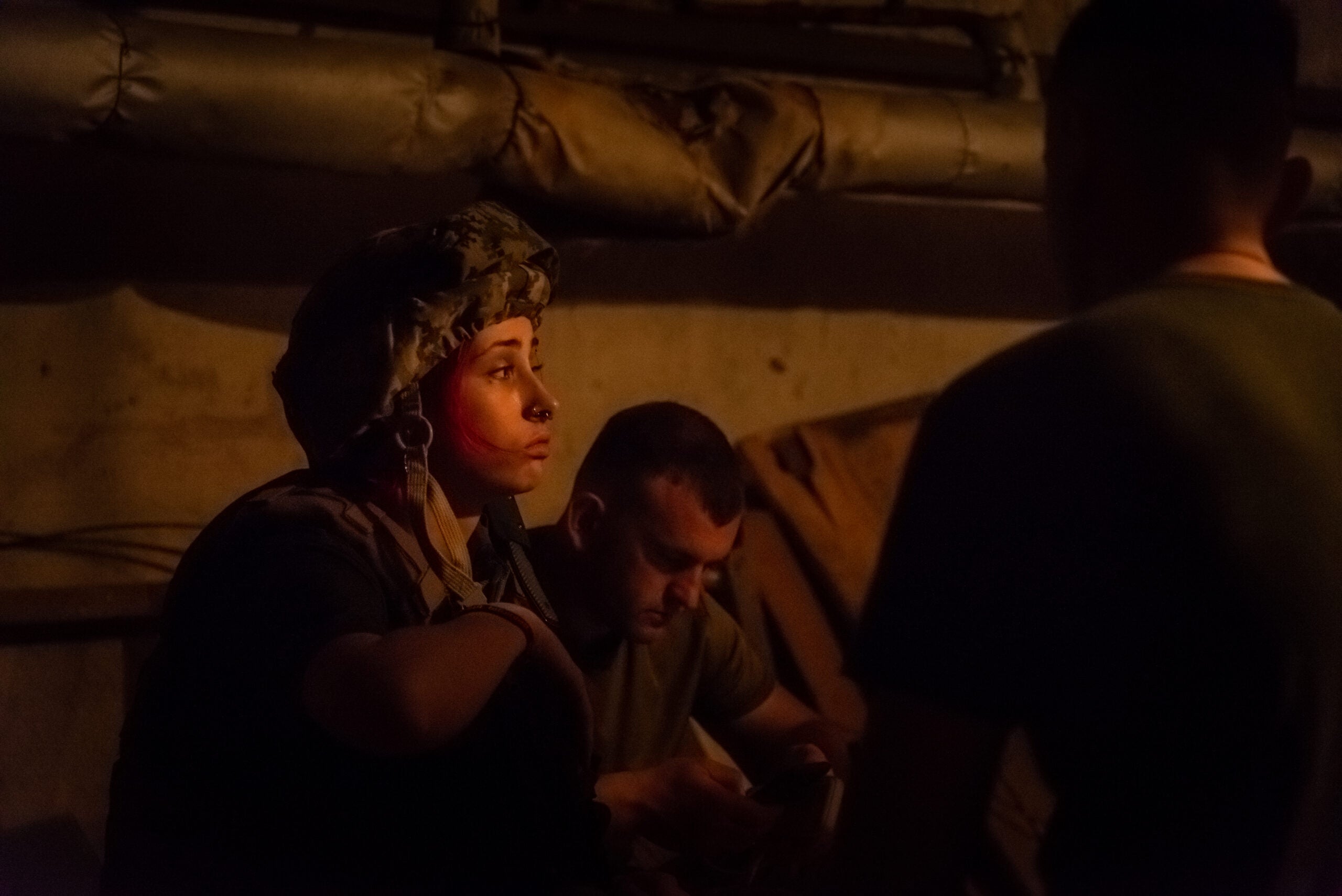 A volunteer member of the 206th battalion of the Kiev territorial defense, seen in a shelter during a bomb alarm, in a fighting position between Mykolaiv and Kherson, Ukraine, on May 31, 2022. (Matteo Placucci/NurPhoto via Getty Images)