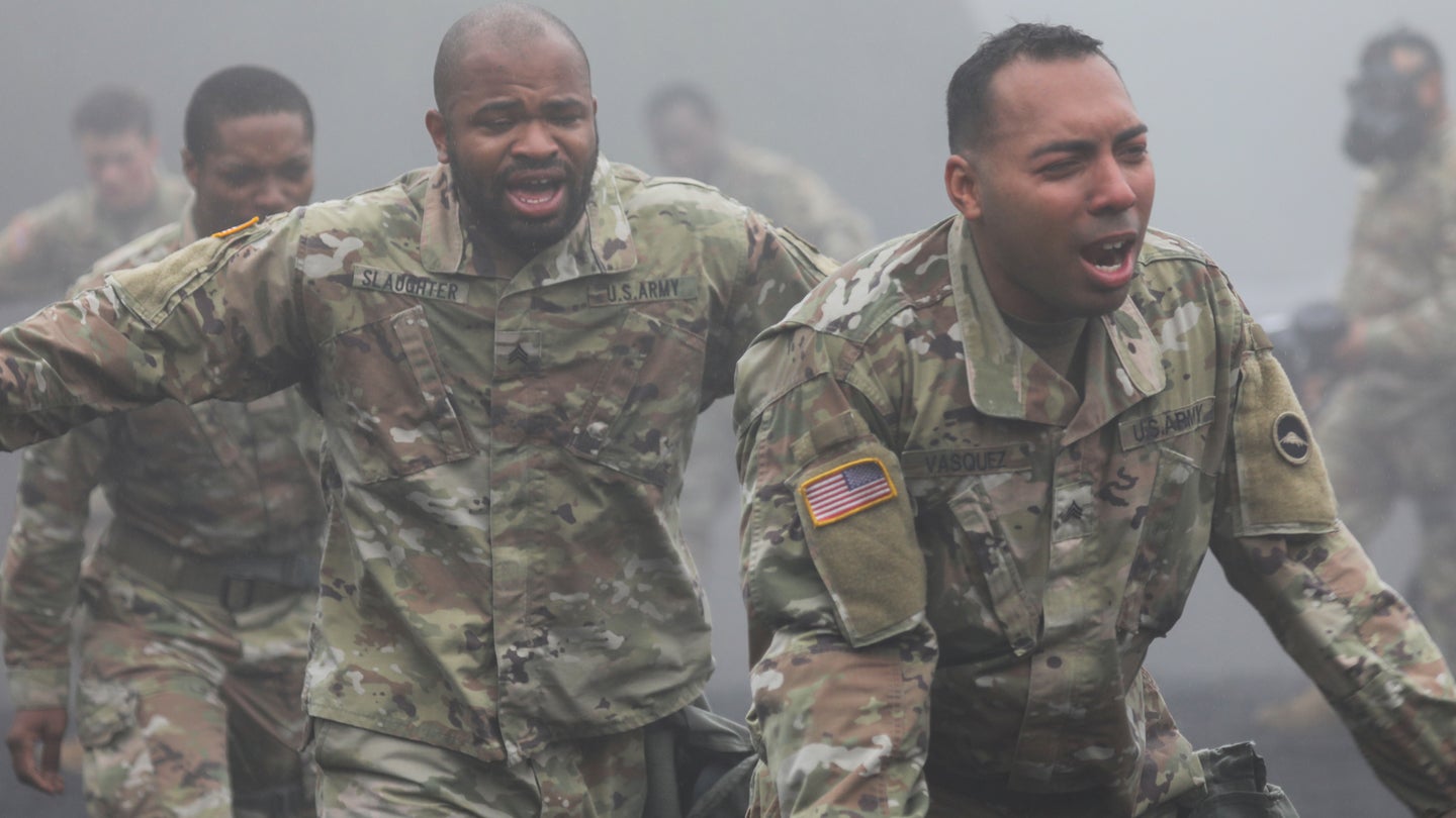 Sgt. Jamal Slaughter, center left, and Sgt. Nowell Vasquez exit a gas chamber during a training event at the Combined Arms Training Center Camp Fuji, Japan, June 23, 2022. (Sean Kimmons/U.S. Army)