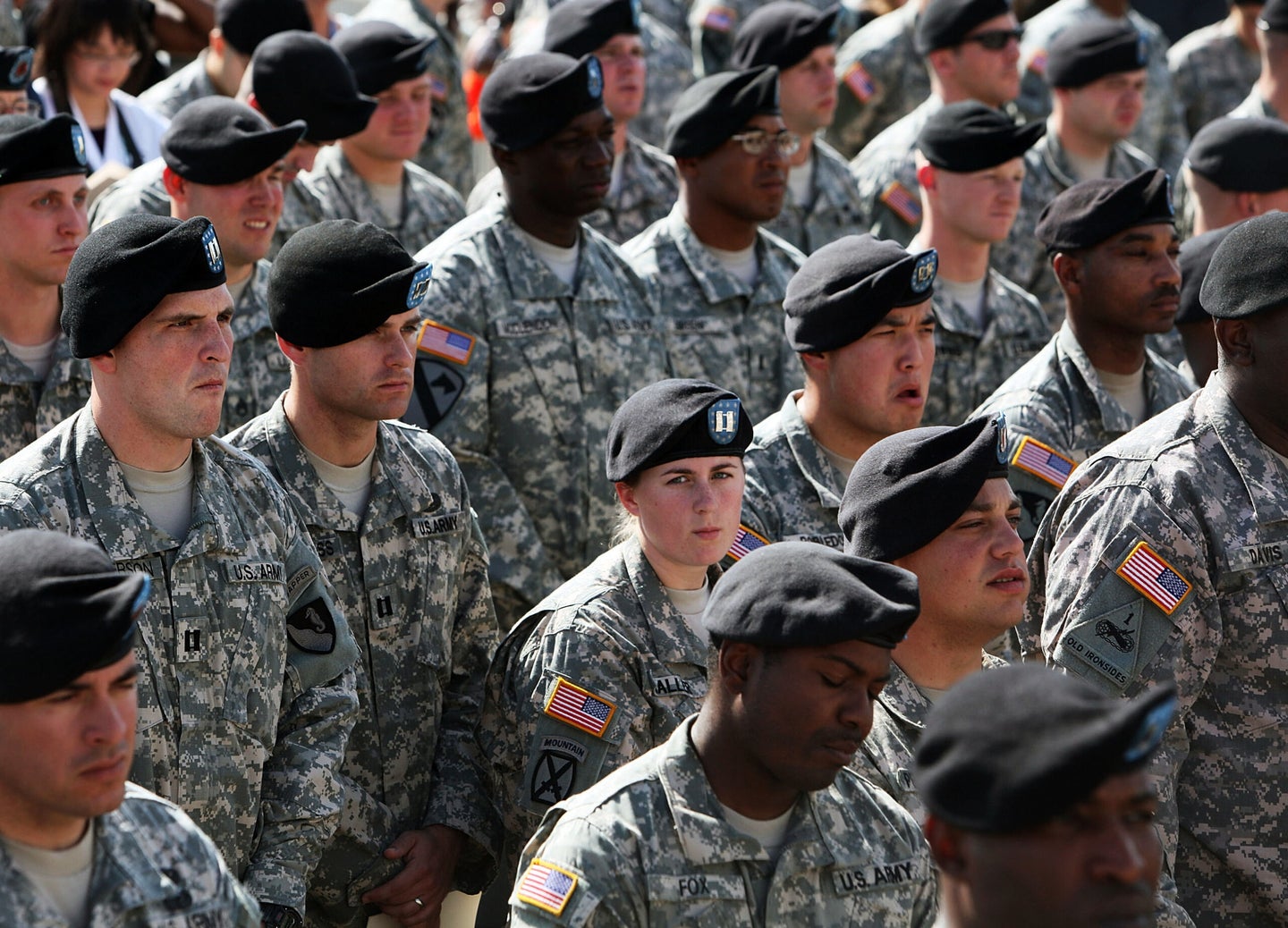 U.S. Army soldiers stand together as they wait for the start of memorial service for the thirteen victims of the shooting rampage by U.S. Army Major Nidal Malik Hasan on November 10, 2009 in Fort Hood, Texas. Hasan, an army psychiatrist, killed 13 people and wounded 30 in a shooting at the military base on November 5, 2009.  (Photo by Joe Raedle/Getty Images)