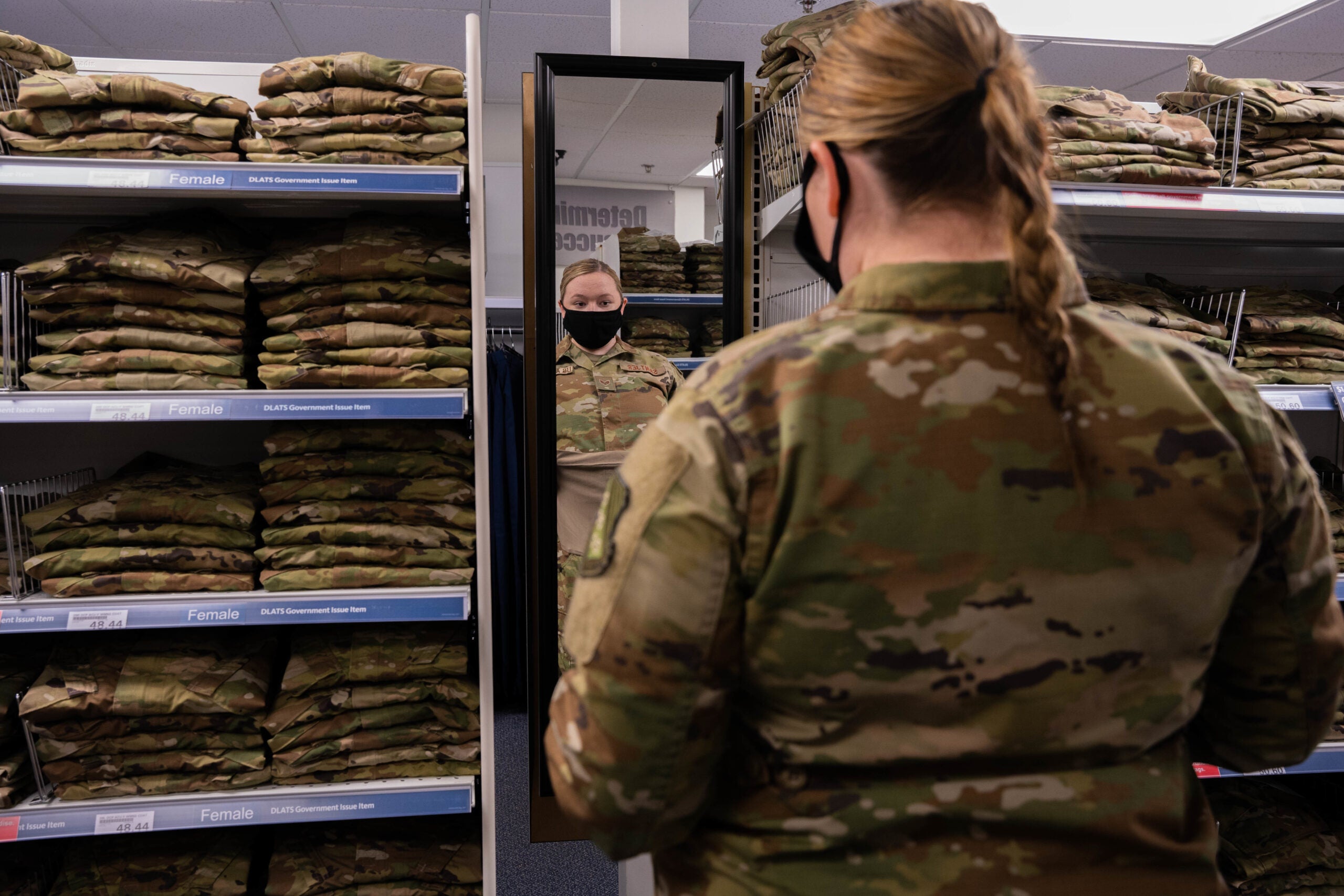 Senior Airman Quynn Santjer, Unit Deployment Manager for the 94th Fighter Squadron, looks through the new abundance of maternity options at Military Clothing Sales at Langley Air Force Base, December 2, 2021. Santjer was happy to know that her co-worker, who is newly pregnant, will not have to wait for uniforms to be shipped to her like she did.