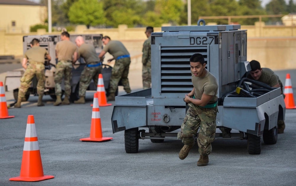 Members of the 92nd Maintenance Squadron and the 92nd Aircraft Maintenance Squadron compete in a power cart obstacle course race at the Maintenance Olympics event at Fairchild Air Force Base, Washington, Aug. 20, 2021. (Staff Sgt. Dustin Mullen / U.S. Air Force)