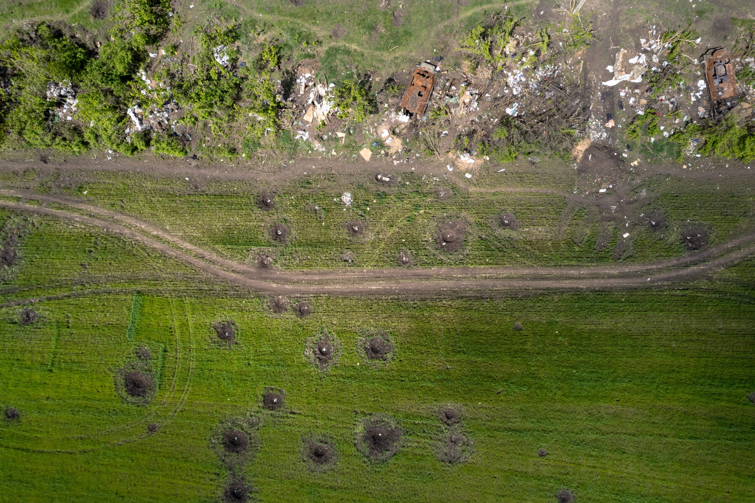 MALAYA ROHAN, UKRAINE - MAY 17:  In this aerial view, impact craters are seen next to an abandoned Russian army encampment in a tree line on May 17, 2022 in Malaya Rohan, Ukraine. For weeks Russia has been withdrawing forces from around Kharkiv, Ukraine's second-largest city, suggesting it may redirect troops to fighting in other areas of eastern Ukraine. (Photo by John Moore/Getty Images)