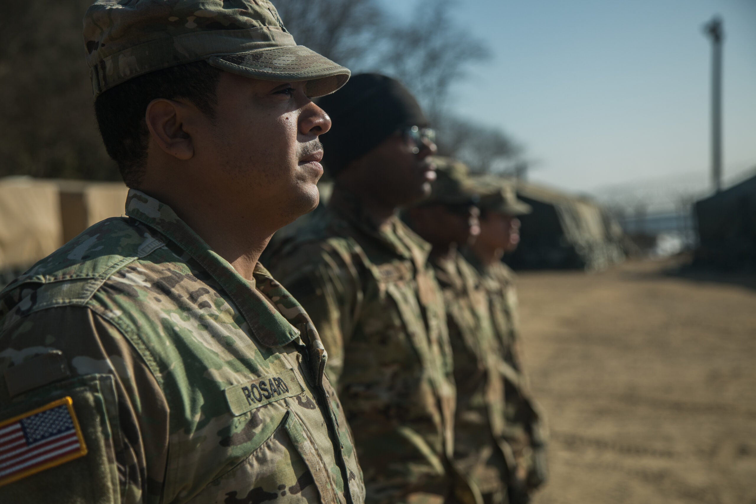 U.S. Army Soldiers, assigned to Bravo Company, 304th Expeditionary Signal Battalion, 1st Signal Brigade, stands at attention during Spc. Alister Pierce re-enlistment ceremony in South Korea, Jan. 30, 2018. Pierce re-enlisted after serving five years in the Army. (U.S. Army photo by Pfc. Isaih Vega)
