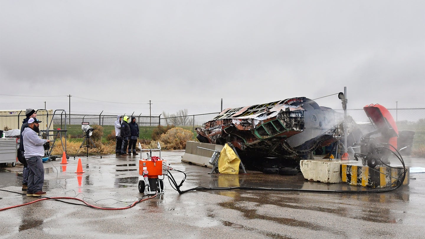 A salvaged F-35A is cut in half with the volunteer help of a civilian saw manufacturing company March 31, 2022, at Hill Air Force Base, Utah. The aircraft was condemned after an accident and is currently being transformed into sectional training aids by the 372nd Training Squadron, Det. 3, for use during instruction of F-35 maintainers. (Todd Cromar/U.S. Air Force)