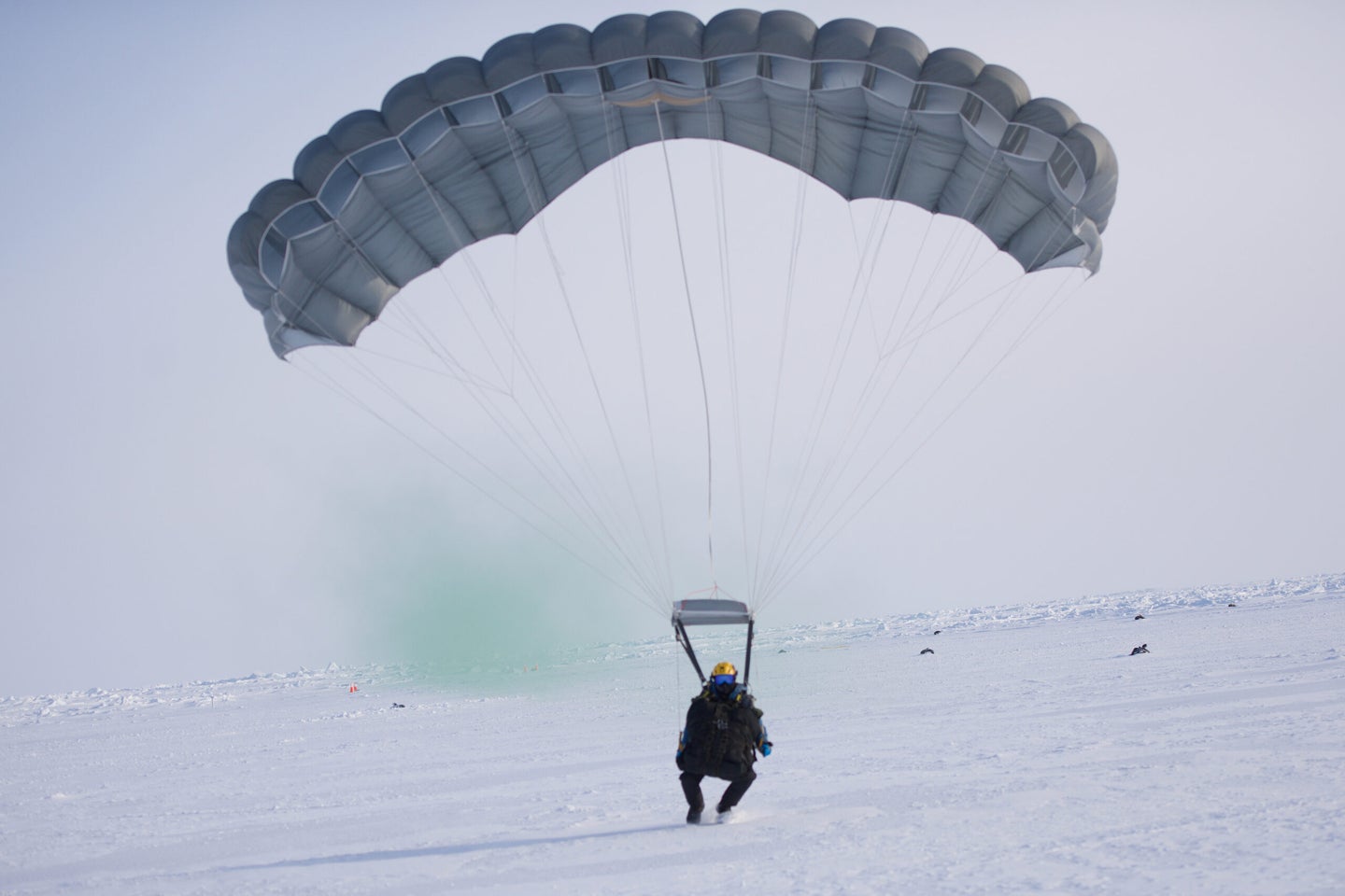 A 212th Rescue Squadron combat rescue officer from the Alaska Air National Guard lands at the U.S. Navy’s Ice Camp Queenfish on the arctic ice pack March 14, 2022. (Master Sgt. Benjamin Westveer, U.S. Air National Guard)