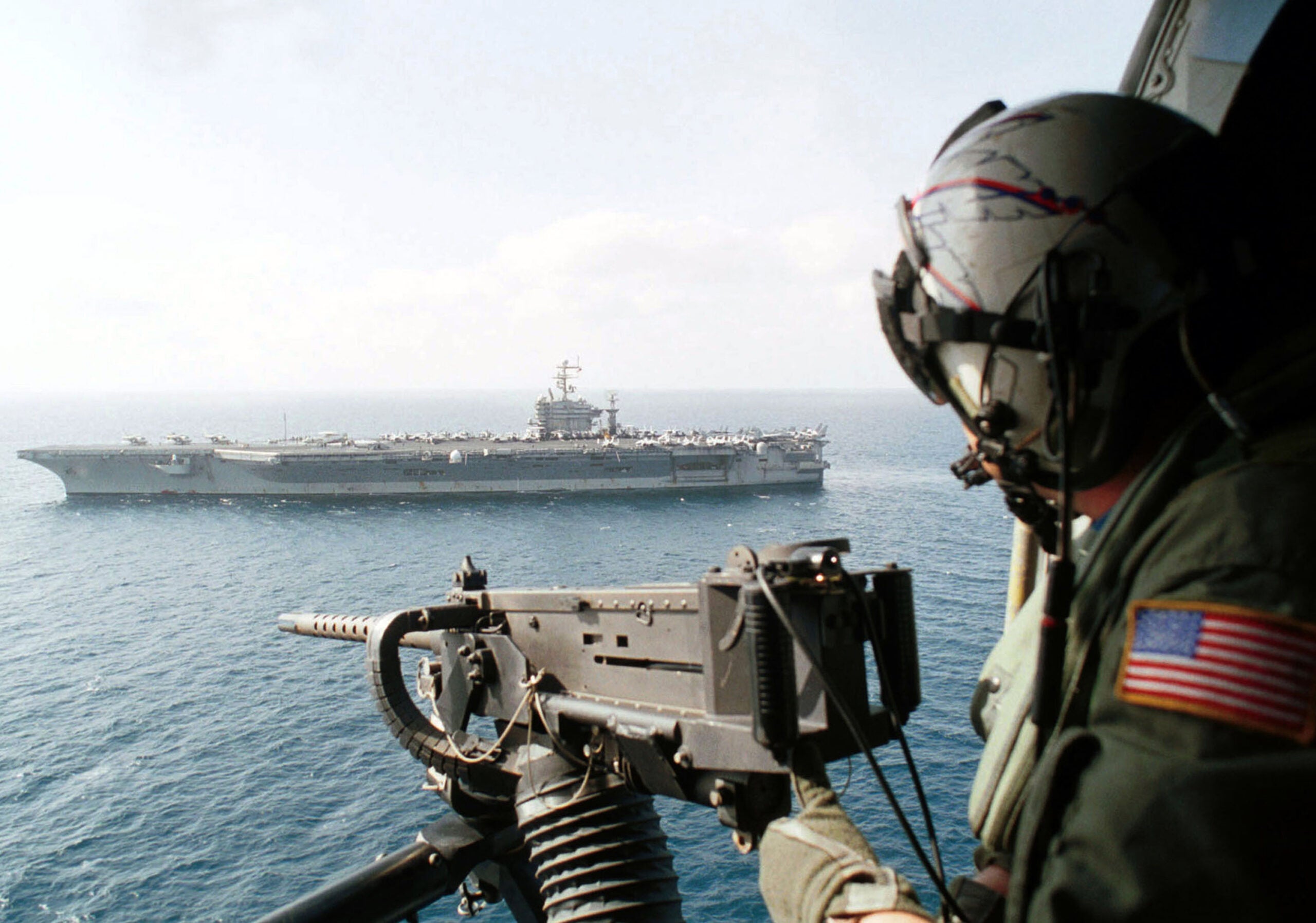 395173 01: A Chief Aviation Warfare Systems Operator scans the horizon above USS Carl Vinson from behind his GAU-16 50 caliber machine gun aboard an SH-60H "Seahawk" helicopter September 24, 2001 at sea in Southwest Asia. The USS Carl Vinson Battle Group is on a scheduled deployment. (Photo by Chief Photographer's Mate Daniel E. Smith/U.S. Navy/Getty Images)