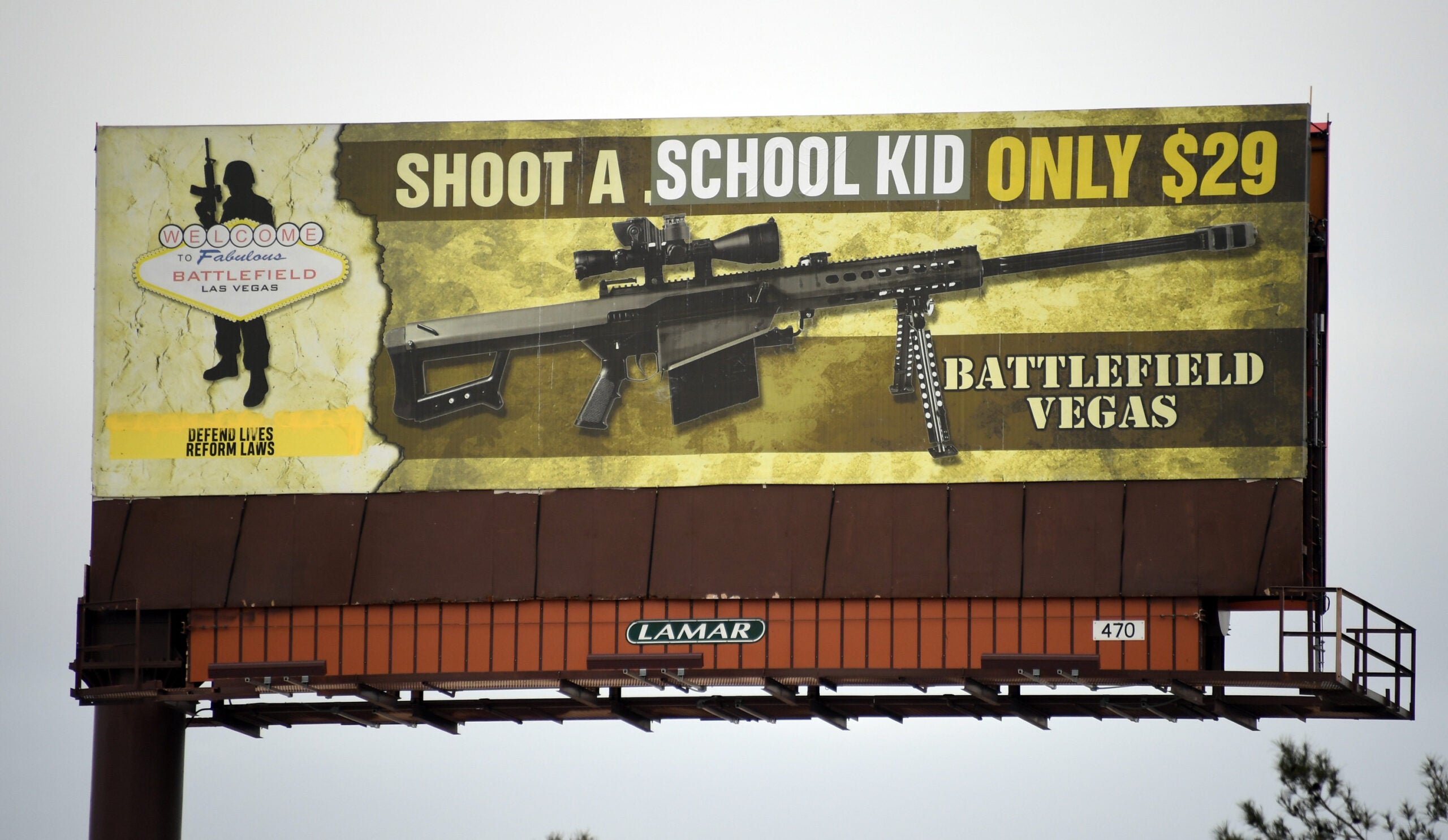 LAS VEGAS, NV - MARCH 01: A billboard poster for the Battlefield Vegas shooting range is shown after it was vandalized on March 1, 2018 in Las Vegas, Nevada. The activist art collective Indecline took responsibility for putting the words "SCHOOL KID" over the words ".50 CALIBER" on the sign as well as "DEFEND LIVES REFORM LAWS." Indecline released a statement saying that the protest piece is a response to American's obsession with gun culture and the government's ties with the NRA and called on politicians to work on reforming gun laws.  (Photo by Ethan Miller/Getty Images)