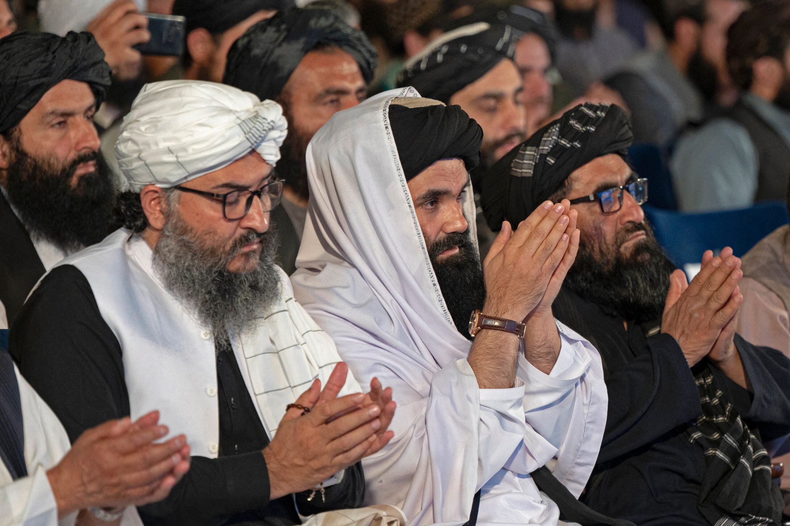 Taliban Interior Minister Sirajuddin Haqqani (C) prays during a ceremony marking the 30th anniversary of the Mujahideen, the 8th of Saur 1371 (28 April 1992) victory over the government of communist regime, in Kabul on April 28, 2022. (Photo by Wakil KOHSAR / AFP) (Photo by WAKIL KOHSAR/AFP via Getty Images)