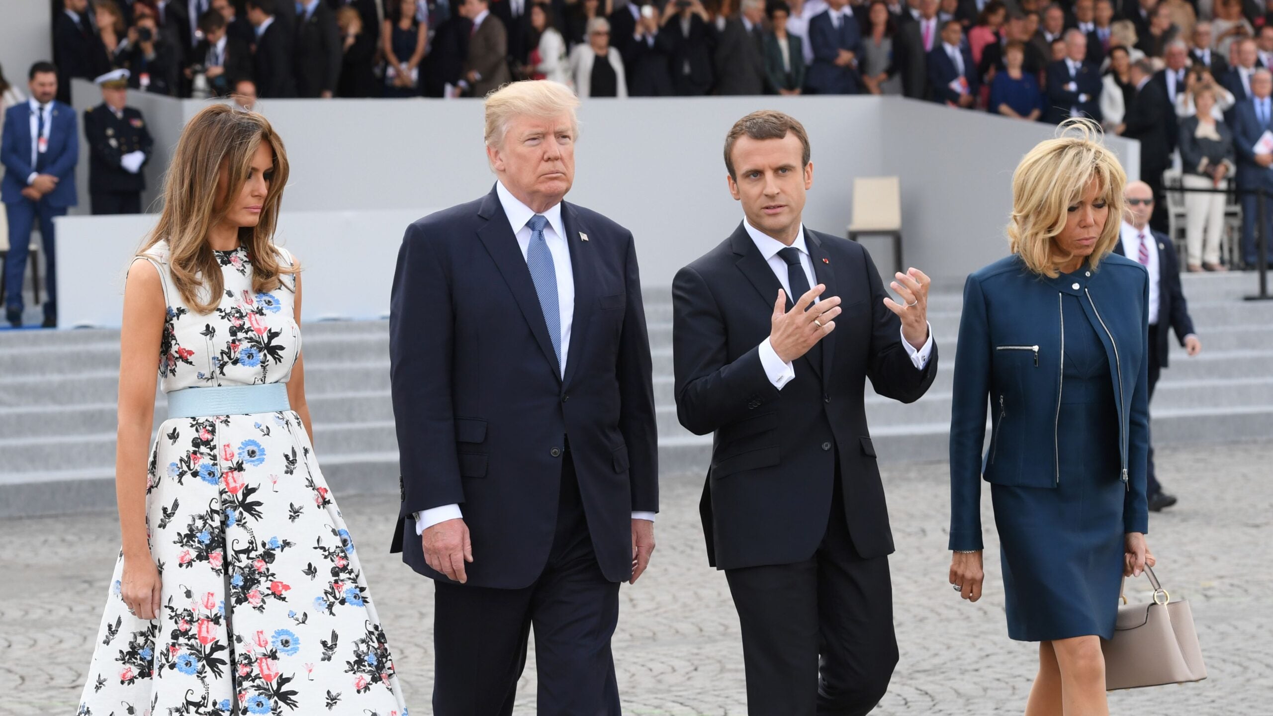 French President Emmanuel Macron (2nd R) and his wife Brigitte Macron walk with US President Donald Trump (2nd L) and US First Lady Melania Trump after attending the annual Bastille Day military parade on the Champs-Elysees avenue in Paris on July 14, 2017.
The parade on Paris's Champs-Elysees will commemorate the centenary of the US entering WWI and will feature horses, helicopters, planes and troops. / AFP PHOTO / POOL / CHRISTOPHE ARCHAMBAULT        (Photo credit should read CHRISTOPHE ARCHAMBAULT/AFP via Getty Images)