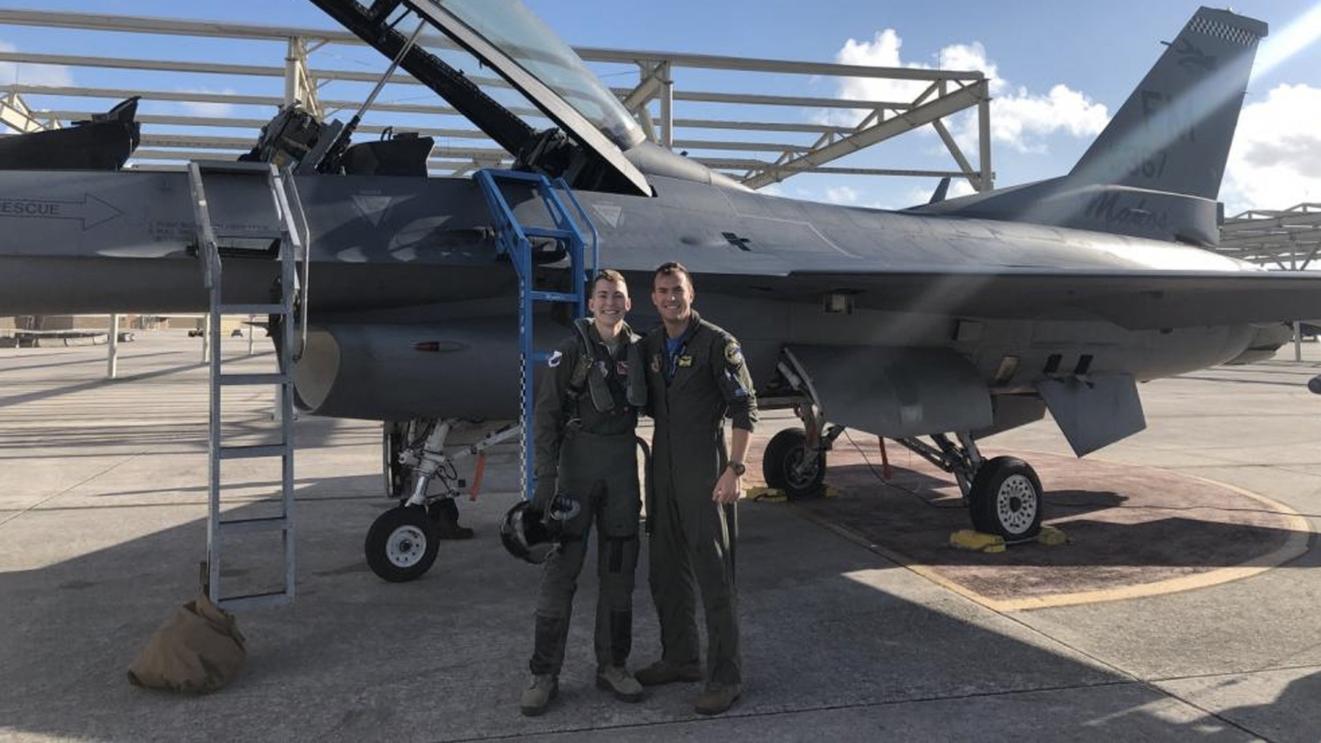 U.S. Air Force 1st Lt. Chad Chapman (left), 47th Student Squadron T-38 Talon student pilot, poses with his older brother, Capt. James Chapman (right), in front of an F-16D. (U.S. Air Force courtesy photo)