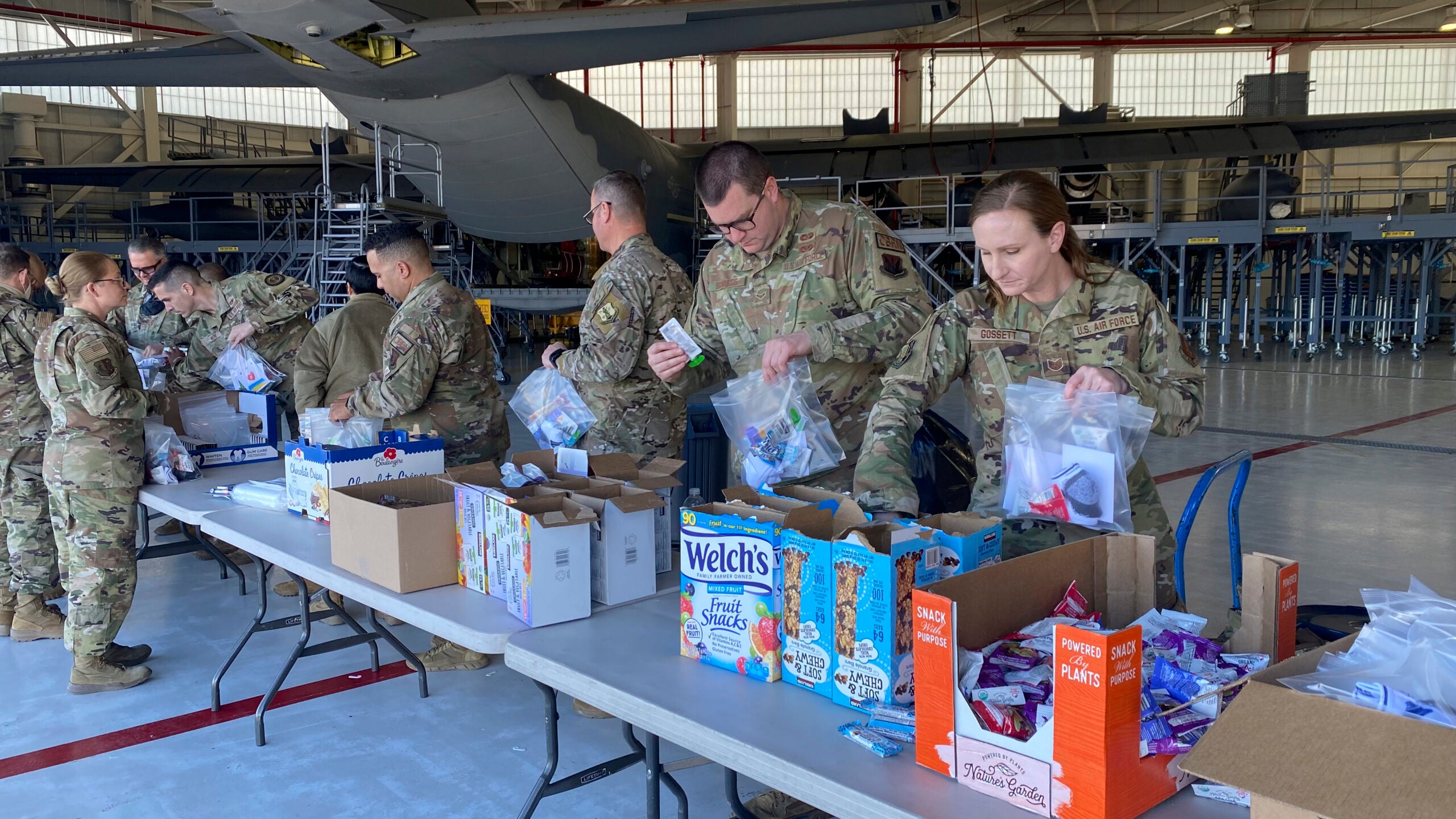 In support of Ukraine, our partner nation under the National Guard's State Partnership Program, Airmen from the 129th Rescue Wing came together to build care packages, March 8, 2022, at Moffett Air National Guard Base, California.  the packages will be sent overseas and given to Ukranian refugees displaced by the war with Russia.  The Airmen filled over 300 bags with socks, snacks and oral hygiene items that were donated by funds from the wing's Top 3 and Chief's Group for the humanitarian aid.  (U.S. Air National Guard photo by Master Sgt. Ray Aquino)