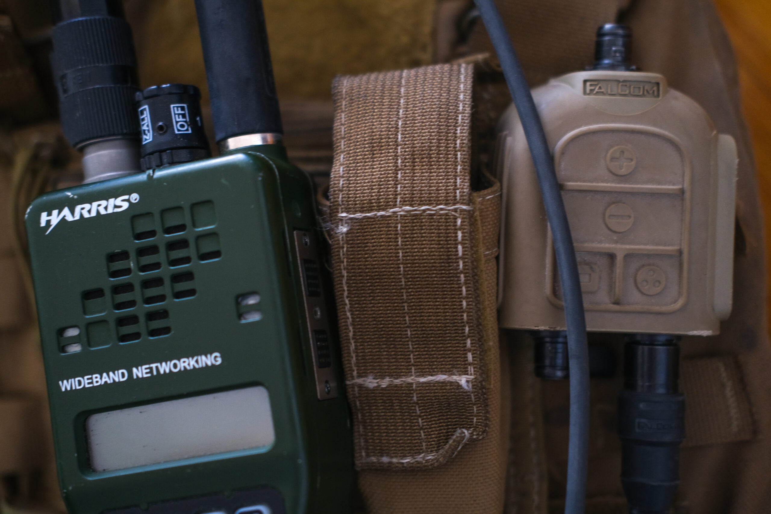 The MFC 2000 mounted to the authors vest and connected to a TRI PRC-152 replica to represent the real radio and test connectors.