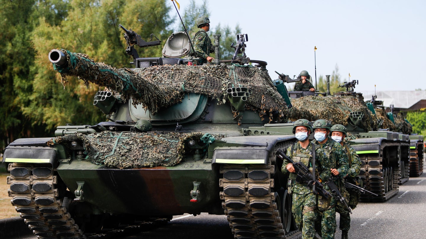 Soldiers patrol as Tanks are deployed during a shore defense operation as part of a military exercise simulating the defense against the intrusion of Chinese military, amid rising tensions between Taipei and China, in Tainan, Taiwan, 11 November 2021. (Ceng Shou Yi/NurPhoto via Getty Images)