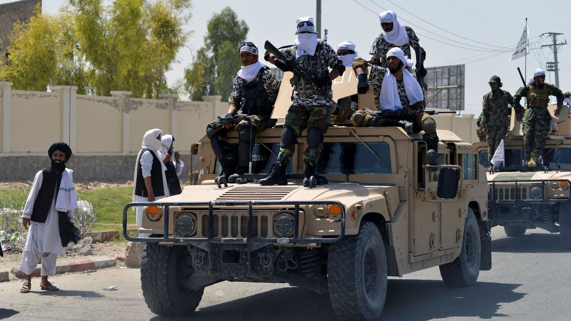 Taliban fighters atop Humvee vehicles parade along a road to celebrate after the US pulled all its troops out of Afghanistan, in Kandahar on September 1, 2021 following the Talibans military takeover of the country. 