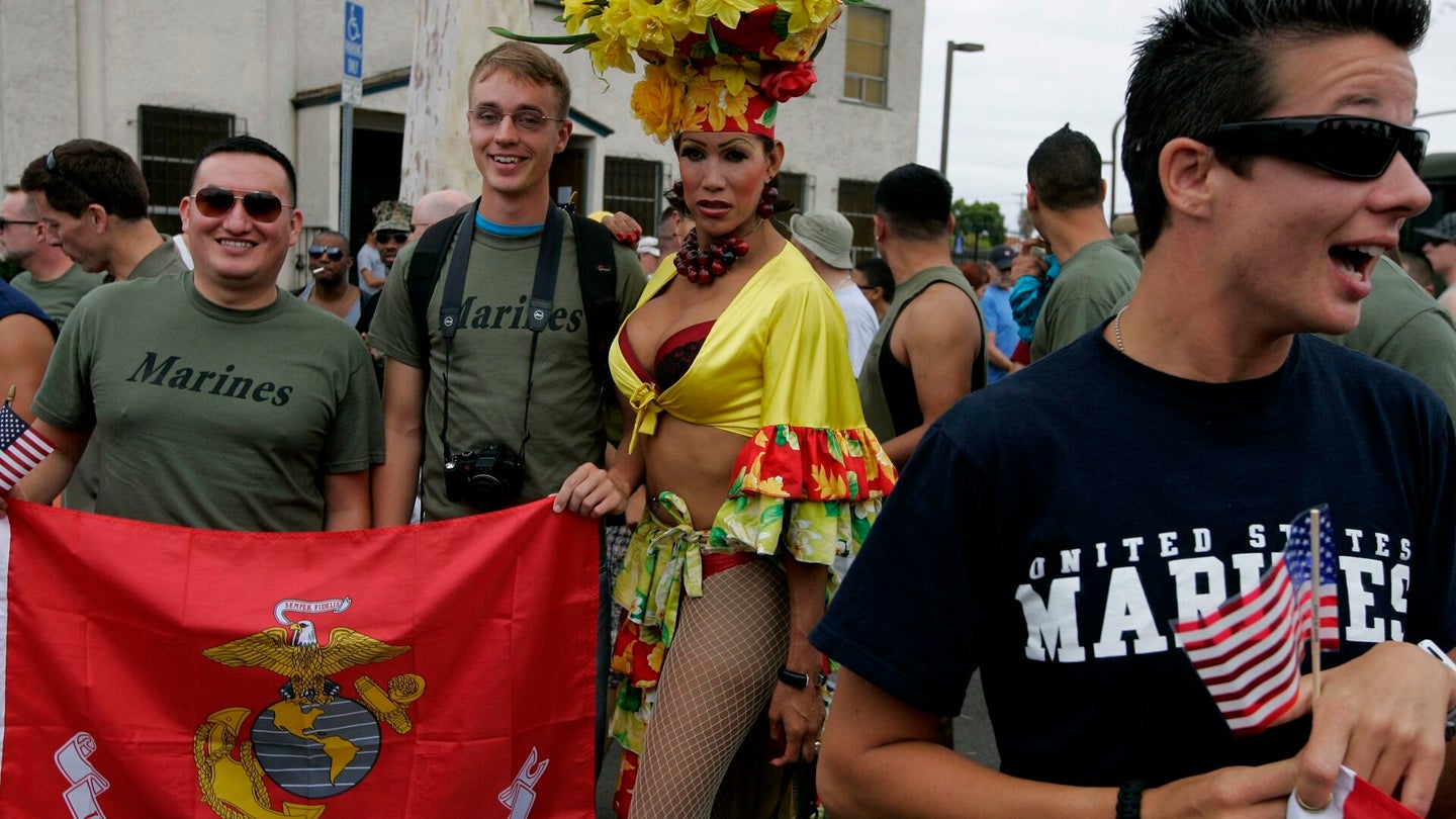 Navy and Marine Corps personnel pose for a picture with drag queen Bianca Sullivan before marching in the San Diego gay pride parade July 16, 2011 in San Diego, California. (Sandy Huffaker/Getty Images)
