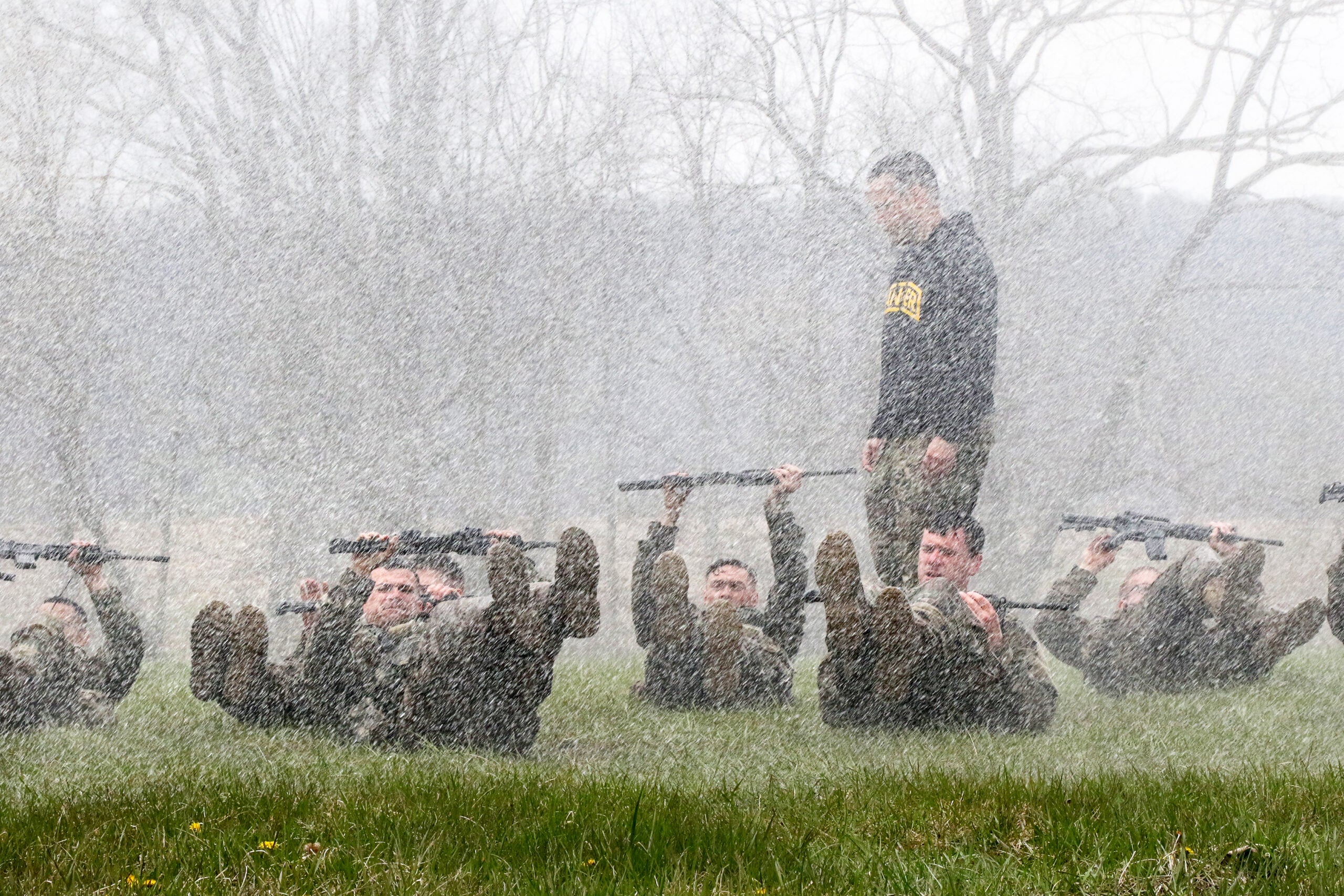 Pennsylvania National Guardsmen lie on their backs and perform flutter kicks while being drenched with water during a Ranger Sapper Assessment Program April 23 at Fort Indiantown Gap, Pa. The Fort Indiantown Gap Fire Department augmented this portion of the course training by providing a fire truck with a bumper turret spray system, which was used to soak trainees as they moved through an individual movement technique lane, performed ranger training tasks, and were pushed to their absolute limits both physically and mentally. This event was designed to prepare them for the infamous Malvesti obstacle course, a wet and muddy confidence course that they will encounter if selected to attend Ranger School. (U.S. Army National Guard photo by Staff Sgt. Shane Smith)