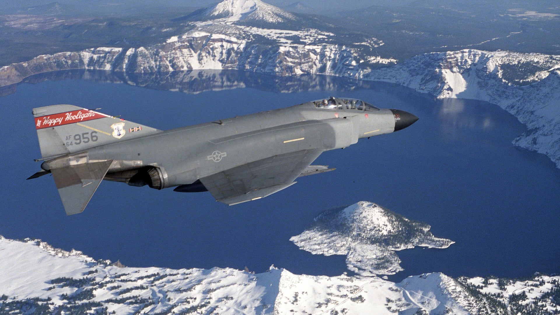 A U.S. Air Force F-4D Phantom II aircraft assigned to the 119th Fighter Wing, North Dakota Air National Guard, flies over Crater Lake, Oregon. (Larry Harrington/U.S. Air Force)