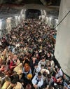 A U.S. Air Force C-17 Globemaster III safely transported 823 Afghan citizens from Hamid Karzai International Airport, Aug. 15, 2021. The initial count of 640 passengers included only adults, inadvertently leaving off 183 children seated in laps as passengers were transported from the flight line. The correct total passenger count of 823 is a record for the C-17. (U.S. Air Force courtesy photo)
