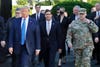 FILE - In this June 1, 2020 file photo, President Donald Trump departs the White House to visit outside St. John's Church, in Washington. Walking behind Trump from left are, Attorney General William Barr, Secretary of Defense Mark Esper and Gen. Mark Milley, chairman of the Joint Chiefs of Staff. Milley put his own job on the line by apologizing for being part of the entourage that accompanied Trump to a photo op outside a church near the White House after peaceful protesters were forcibly removed from the area.   (AP Photo/Patrick Semansky, File)