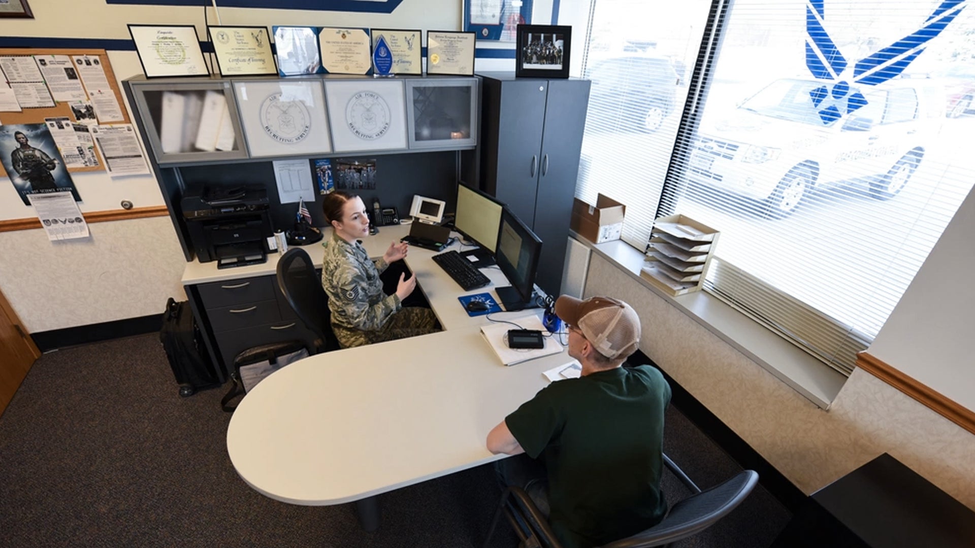 Air Force Tech. Sgt. Kimberly Reeser, recruiter located in Grand Forks, North Dakota, assists recruit with the transition into the military, May 14, 2018. (Airman 1st Class Melody Wolff/U.S. Air Force)