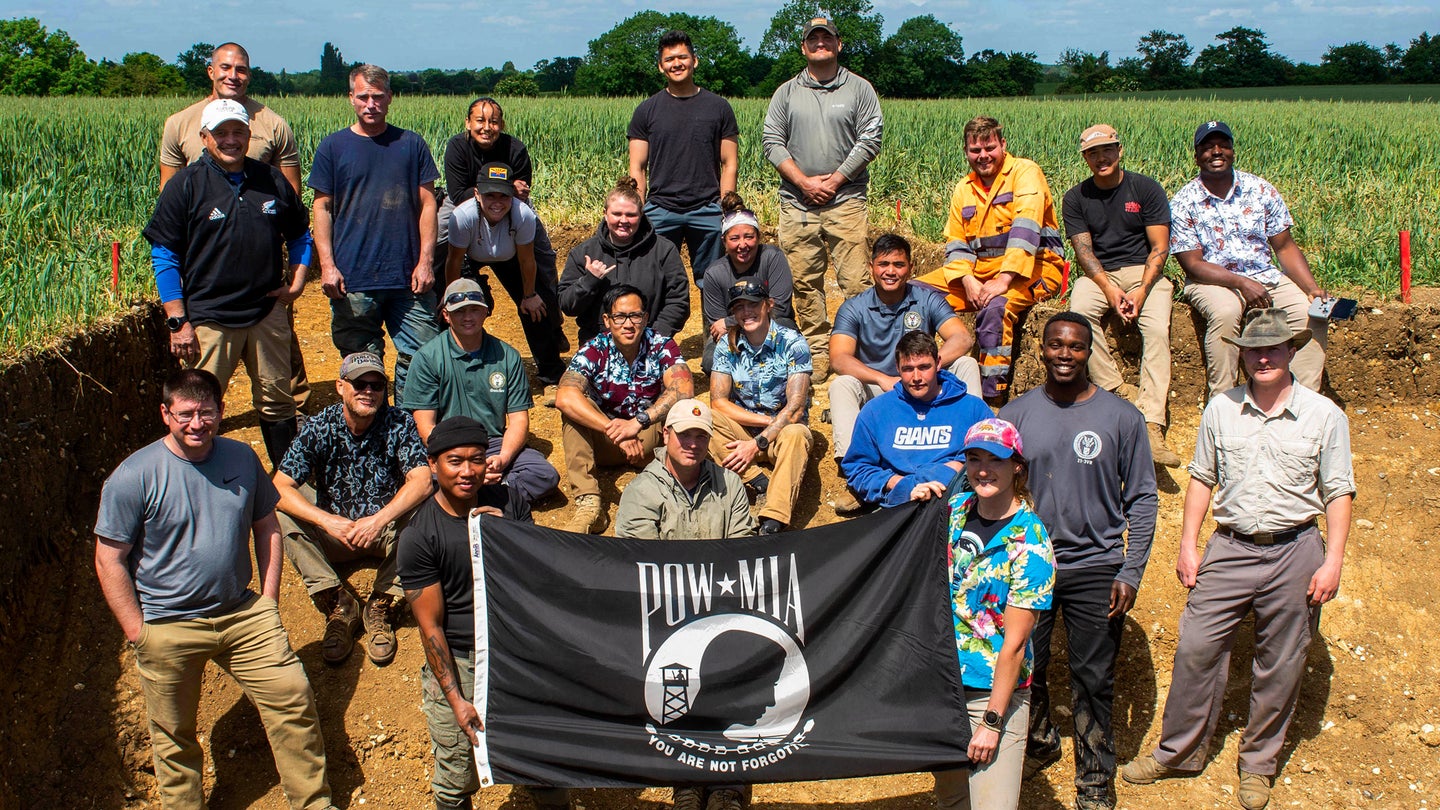 Members of a Defense POW/MIA Accounting Agency (DPAA) recovery team pose for a group photo after completing a recovery mission in England, May 27, 2022. (Staff Sgt. Jonathan McElderry/U.S. Air Force)