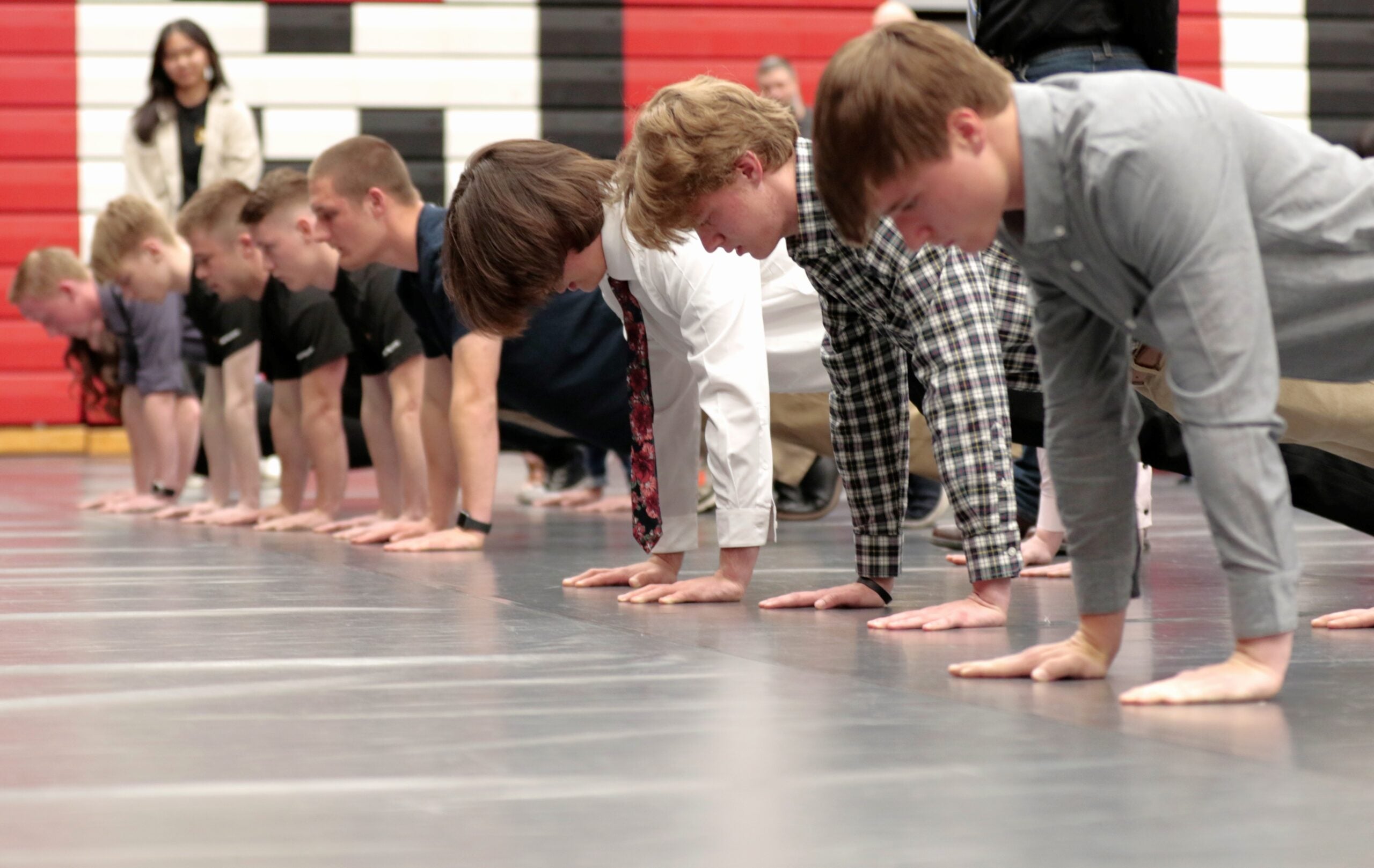 High school military recruits participate in a friendly push-up competition after receiving their oath of enlistment from Lt. Gen. Xavier Brunson, commander of America’s First Corps, at Saint Martin University, Lacey, Wash., May 3, 2022. Recruits were treated to a buffet-style dinner after the oath of enlistment, with family and friends also in attendance. (U.S. Army photo by Spc. Richard Carlisi, I Corps)